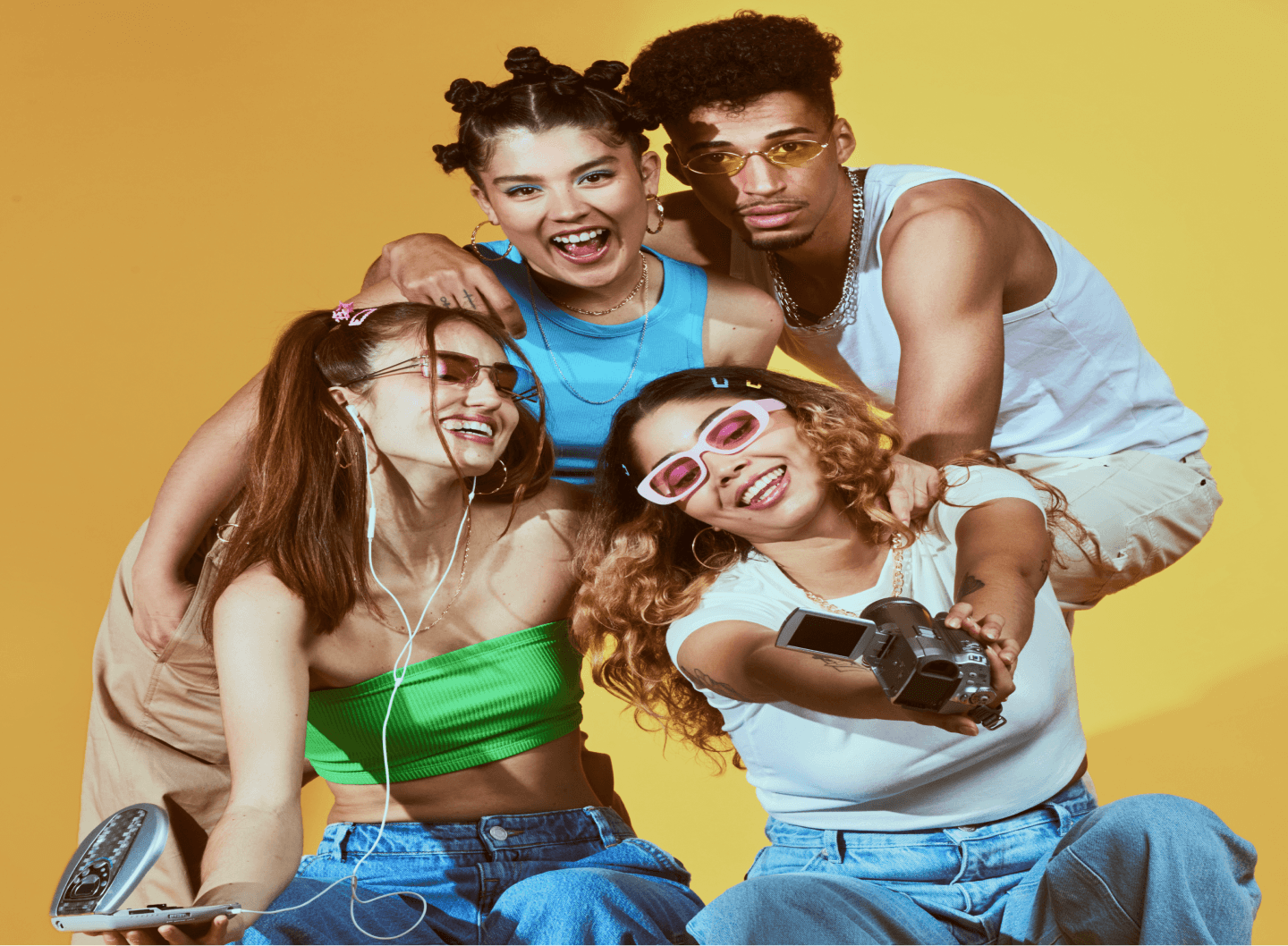 group of friends behind a yellow background